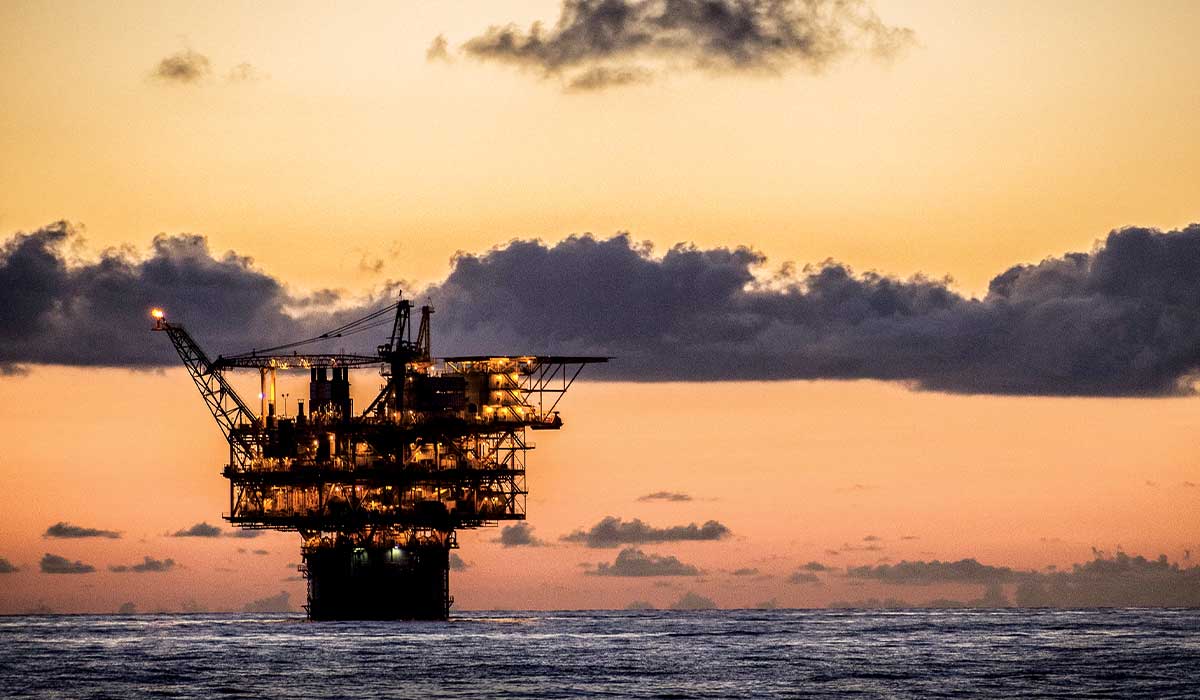Offshore platform in the ocean at sunset