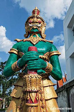 Green statue is a religious artifact. It's holding a sword