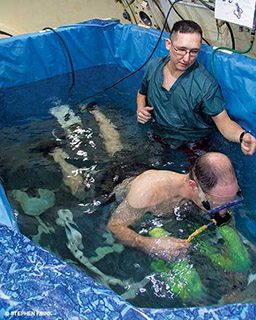 Two people are in a tub ready to perform some experiments.