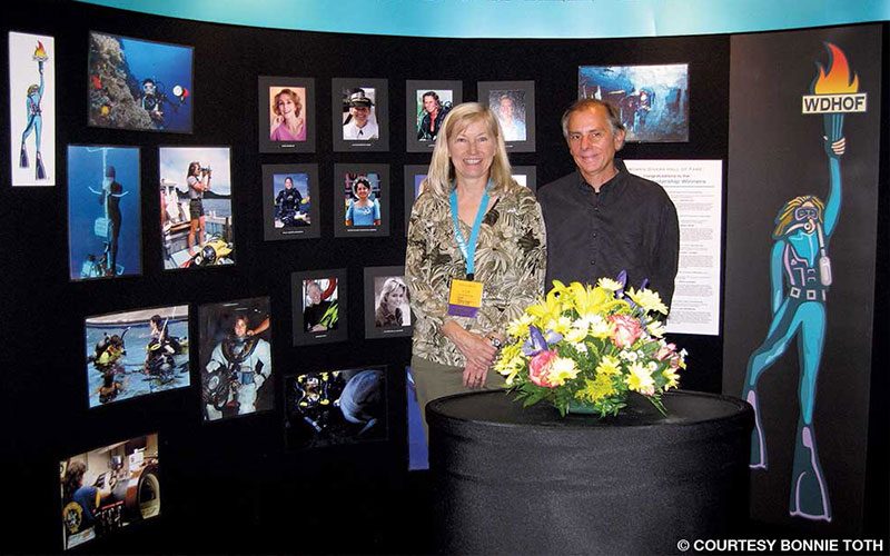Couple stands in front of Women Divers Hall of Fame