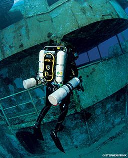 Diver with four tanks dives near shipwreck