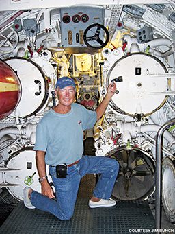 Jim Bunch kneeling with submarine equipment