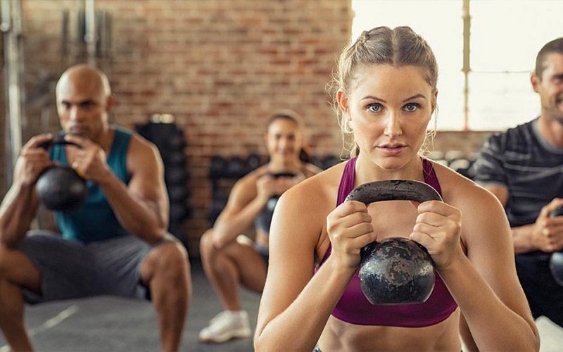 Stock image of woman holding kettlebell