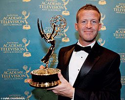 Andy Casagrande poses with his Emmy Award for cinematography.