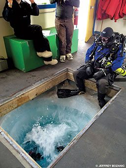 Divers begin their dives from a heated hut, entering through a hole in the floor.