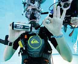 A diver shows off a continuous glucose monitoring device in a waterproof case during a recent study by DAN Europe.