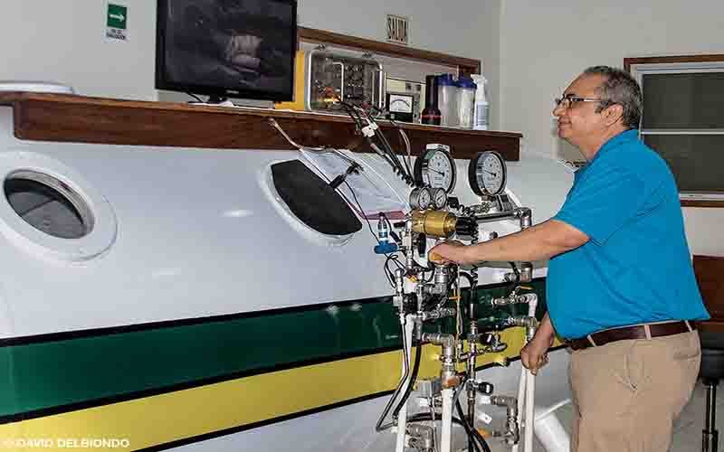 A man is controlling a hyperbaric chamber.