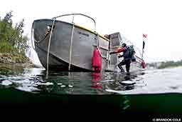 After exploring the waters of British Columbia, a diver climbs back onto the boat.