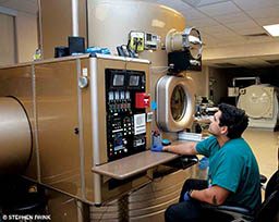 A dive doctor monitors a big fancy machine.