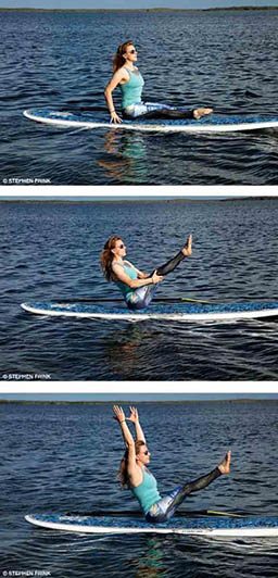A personal trainer is doing boat pose on a paddleboard.