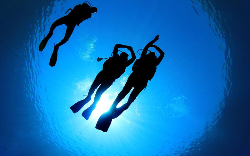 Stock image of three divers