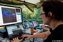 Above water, a programmer tracks the Sunfish vehicle with computer equipment.