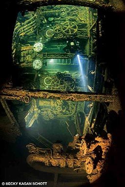 An engine room in a sunken ship is a cool place for a diver to explore.