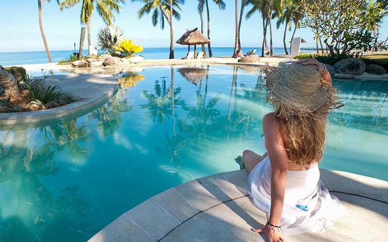 A woman marvels at her uber-expensive tropical resort locale