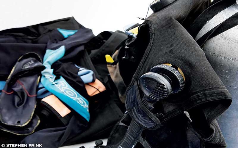 A BCD is photographed with other dive gear