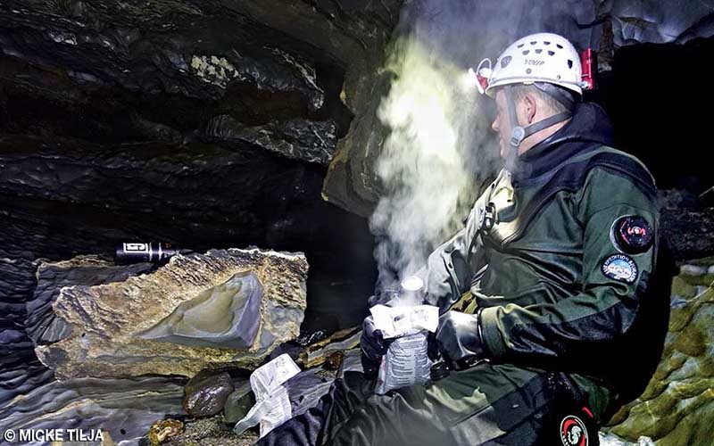 A cave diver takes a little break to warm up.