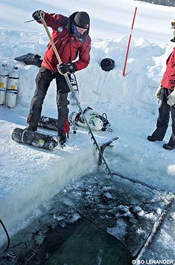Ola Lofquist saws through ice to begin the 2018 expedition.