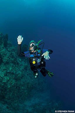 A male diver panics underwater