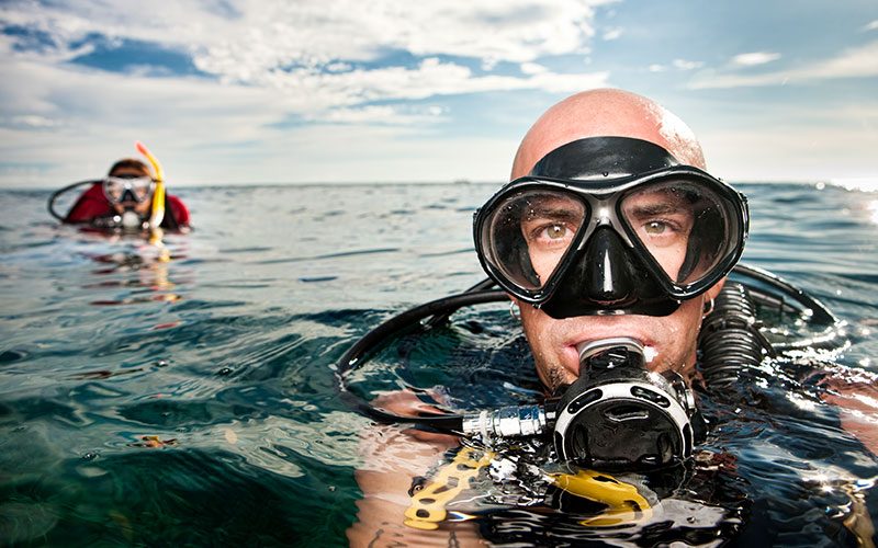 Stock image of two divers just above water