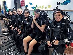 Students in flippers and snorkels are wet after a dive