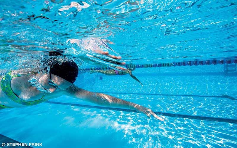 Female swimmer swims laps