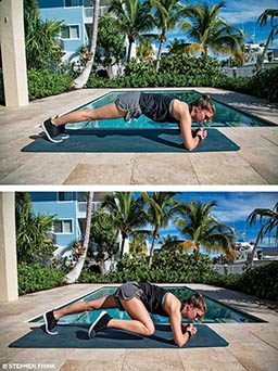 A personal trainer is in plank position and does a mountain climber — driving the right knee to the right elbow