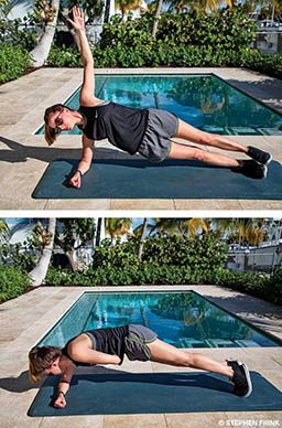 Personal trainer transitions from plank to side plank