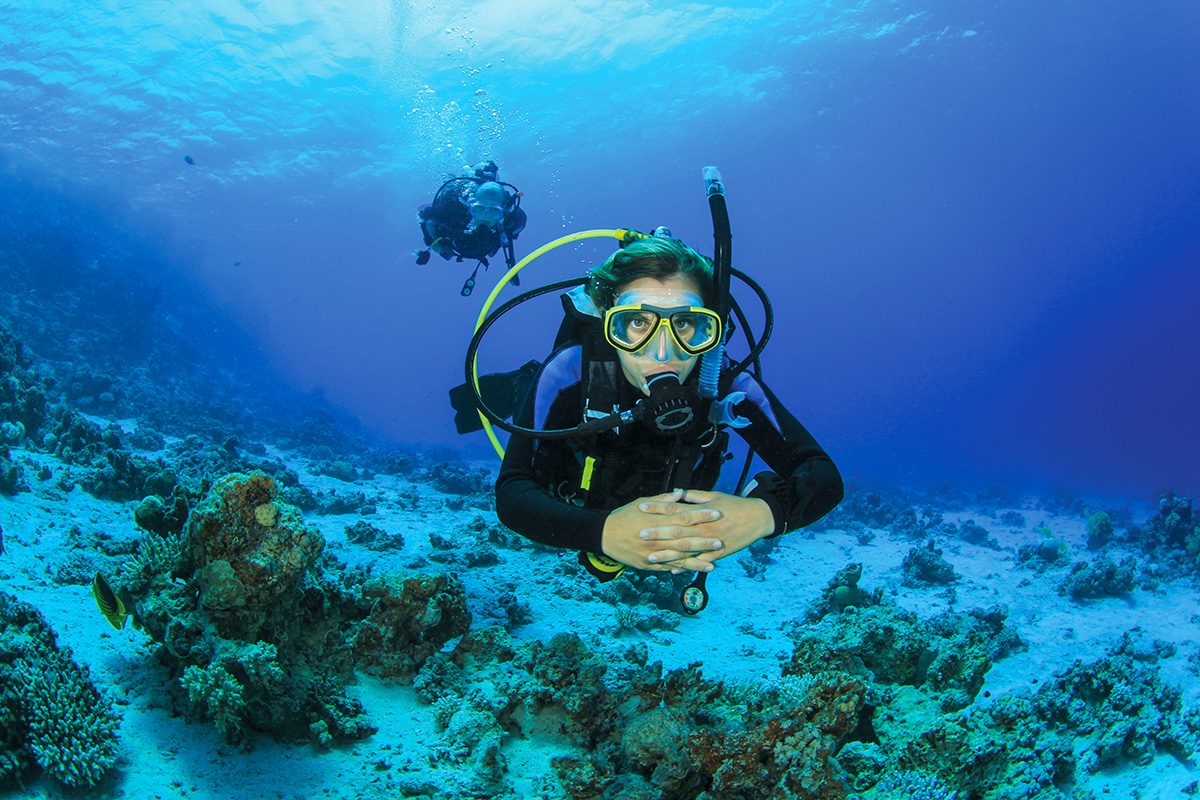 female diver maintains proper buoyancy control