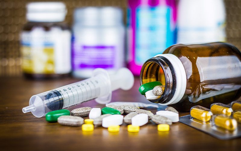 Assortment of pills and fallen pill bottle