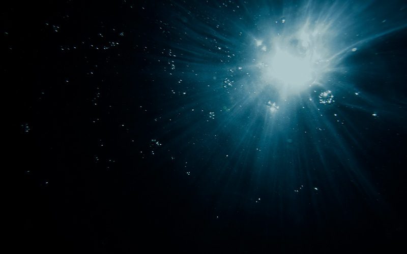 Dark underwater bubbles at night