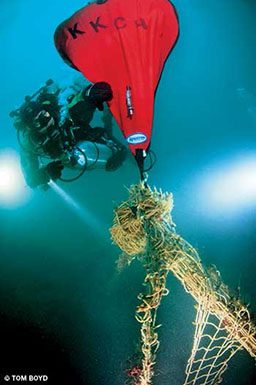 Diver works to remove fishing net