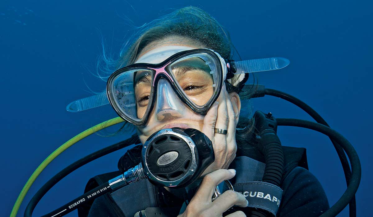 Female diver clutches her mouth