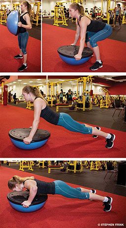 Female personal trainer performs a burpee push-up on BOSU
