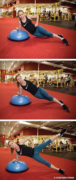 Female personal trainer performs a side-plank drop on BOSU on right side
