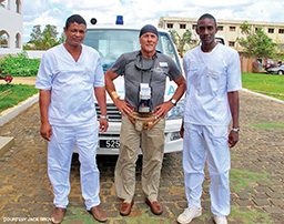 Man stands in between two ambulance staff members