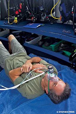 Man is lying down with oxygen mask on