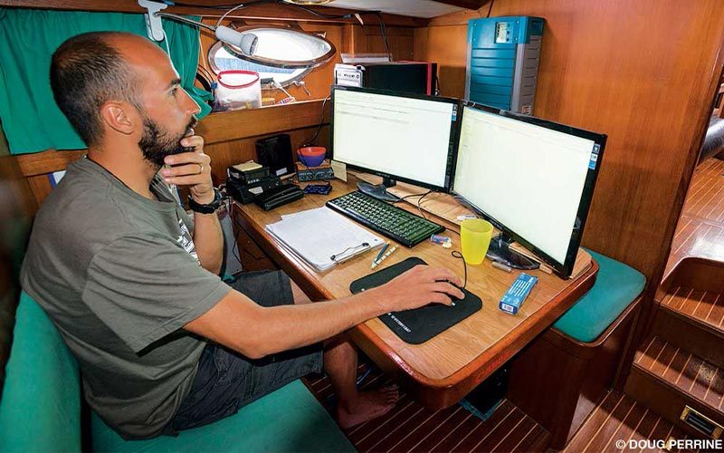 Man on boat clicks at a computer