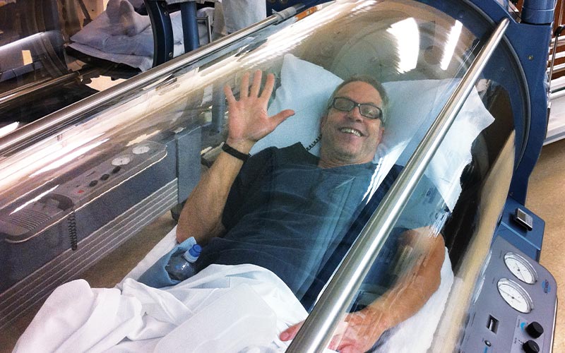 Man waves from hyperbaric chamber