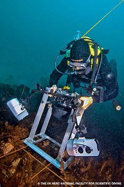 Scientific photographer diver does scientific things underwater