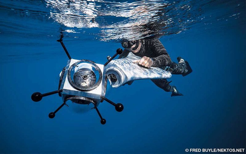 A snorkeler holds a pod that contains six GoPro cameras