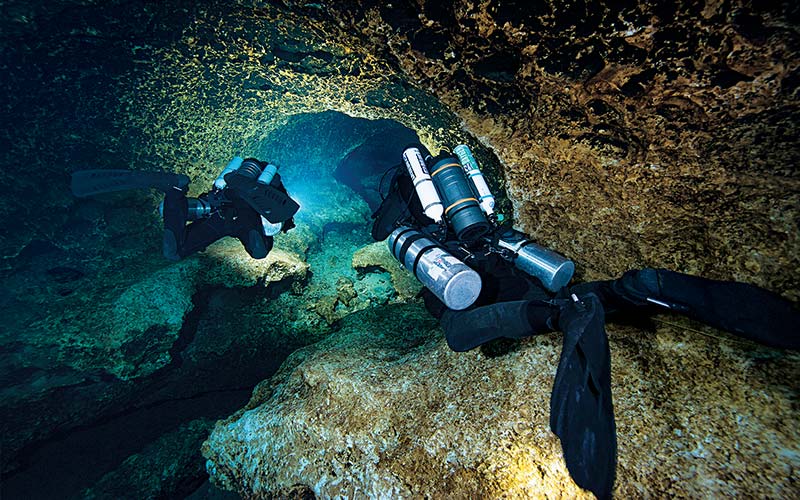 Two cave divers using rebreathers