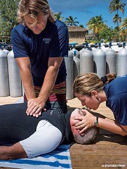 Two people work together to perform CPR