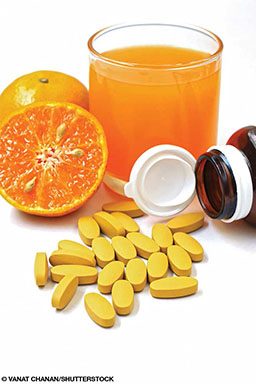 Vitamin C pills, oranges and orange juice