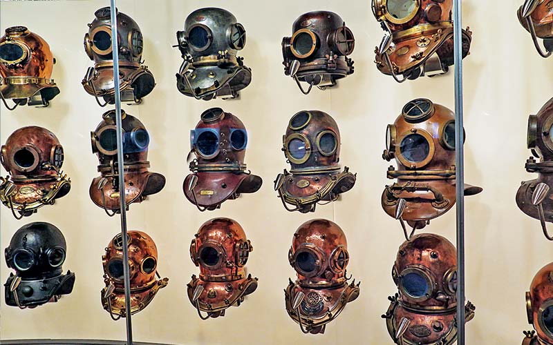 A case full of old diver helmets