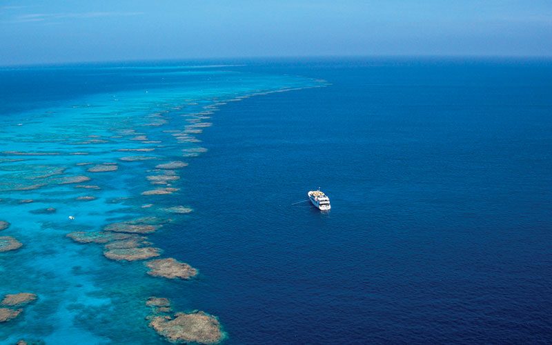 Aerial view of a liveaboard ship in vast ocean waters