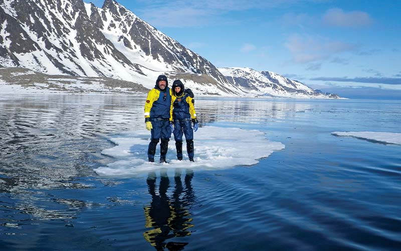 Father and son pose in the arctic