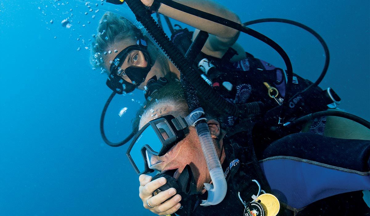 Female diver works hard to tow up an unconscious male diver