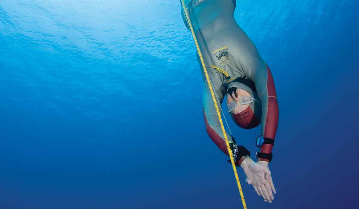 Female freediver heads straight down