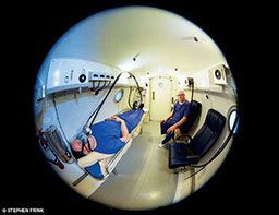 Fish-eye look of patient and doctor in a hyperbaric chamber