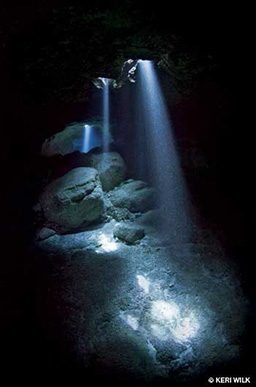 Light shines through holes of a cave